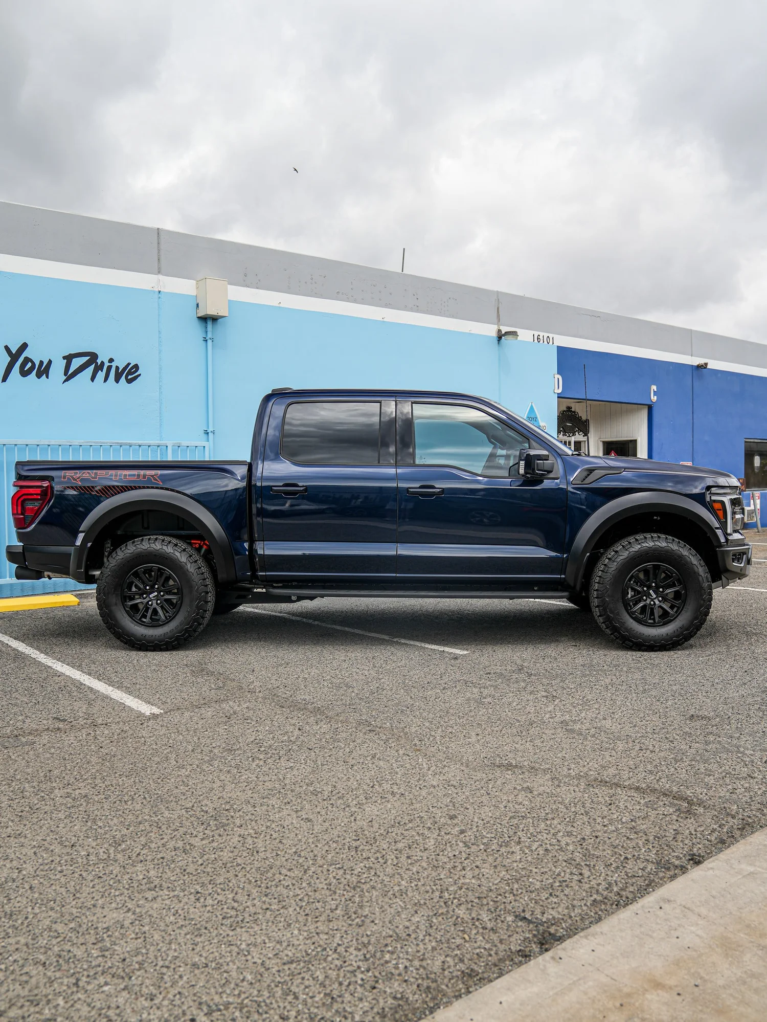 Dark Blue Ford F-150 Raptor after Paint Protection Film (PPF) and Window Tint, left-side profile