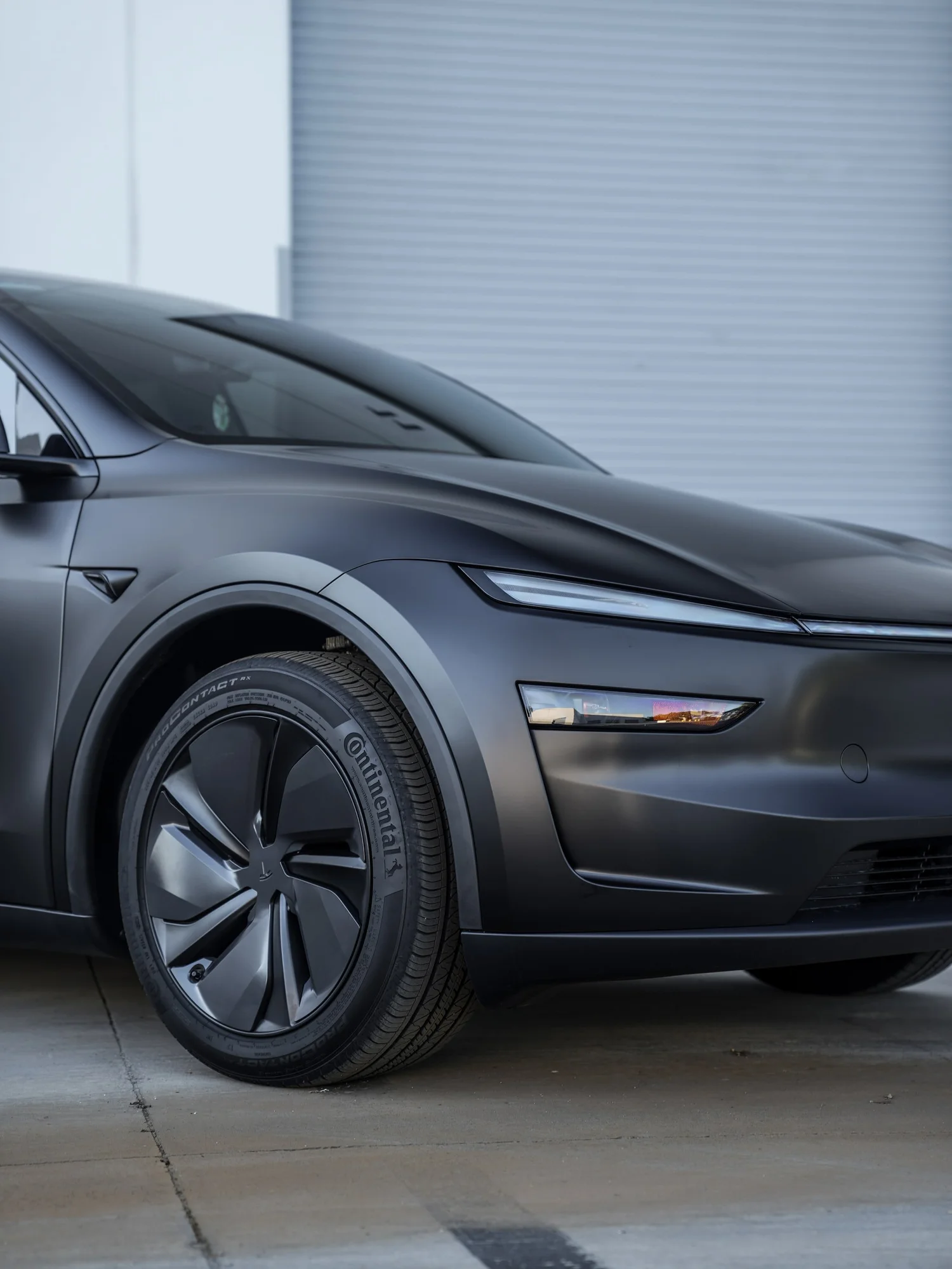 Tesla Model Y 3M Satin Black after Vinyl Wrap, front wheel and body view