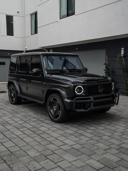 Dark Mercedes-AMG G 63 with contrasting glossy and matte finishes, front three-quarter view