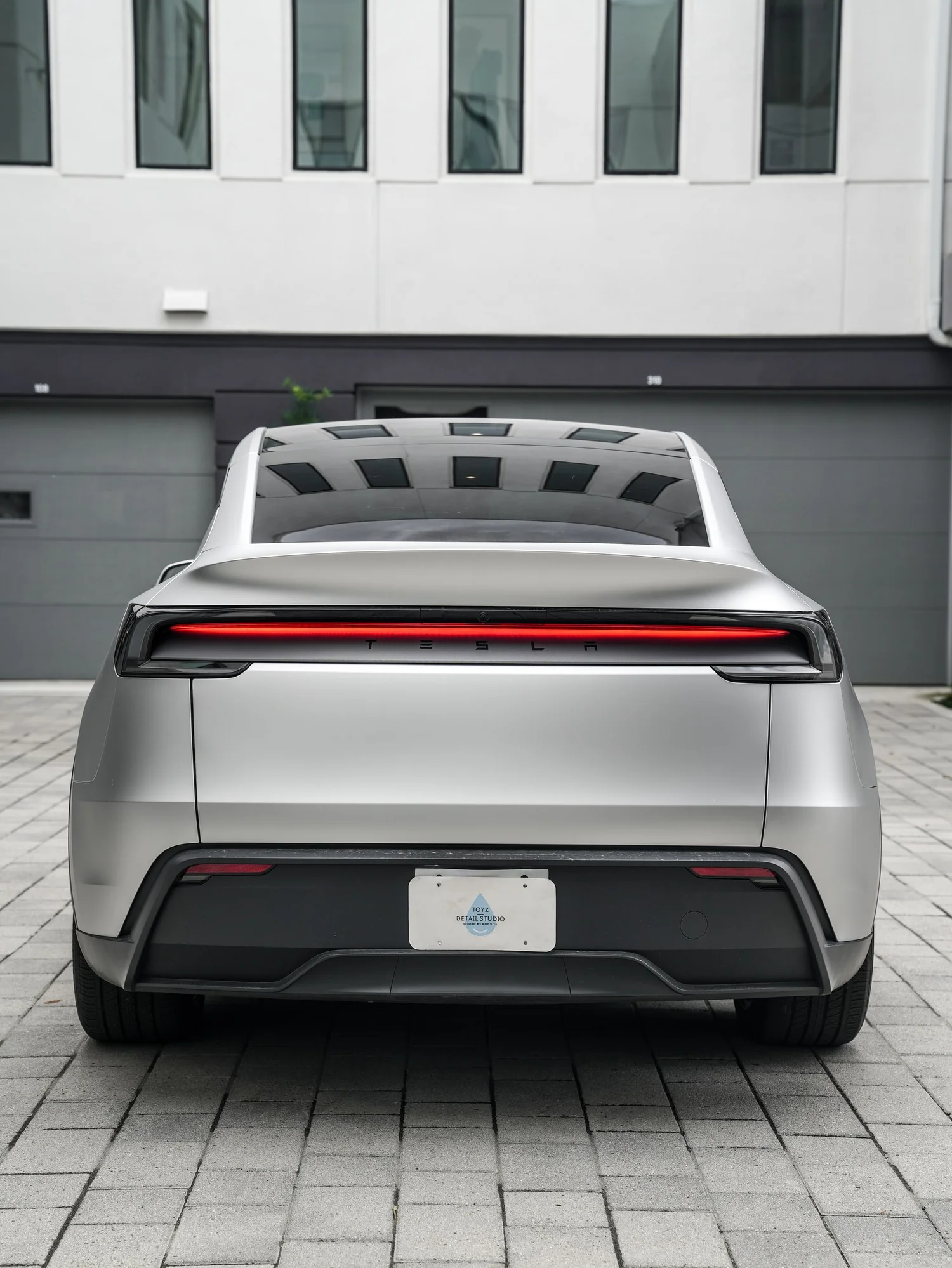 Tesla Model Y TPU Matte Silver Colored PPF after Paint Protection Film (PPF), low-angle rear view