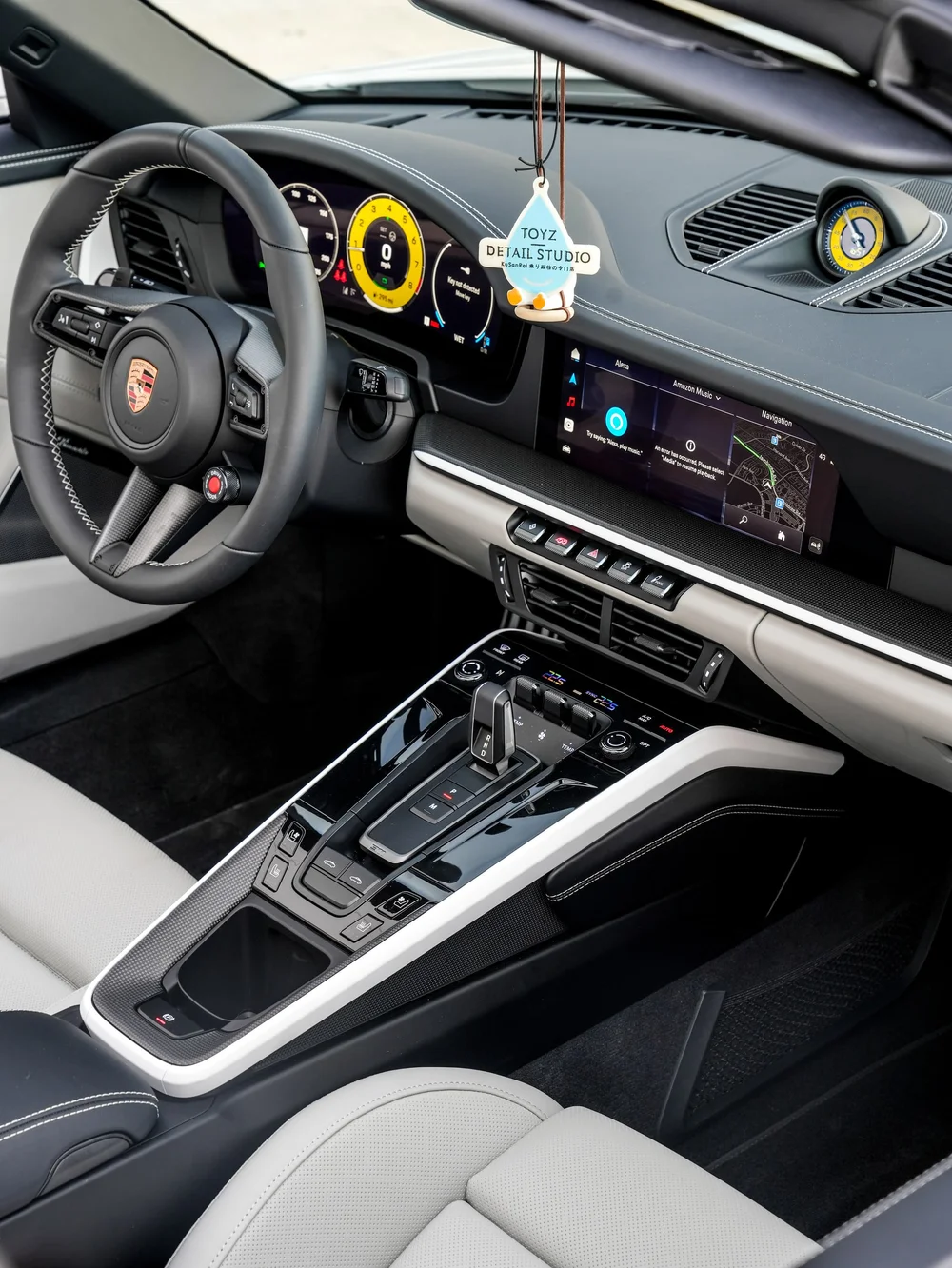 Porsche Targa cockpit with a light seat, dark center console and yellow instrument accents