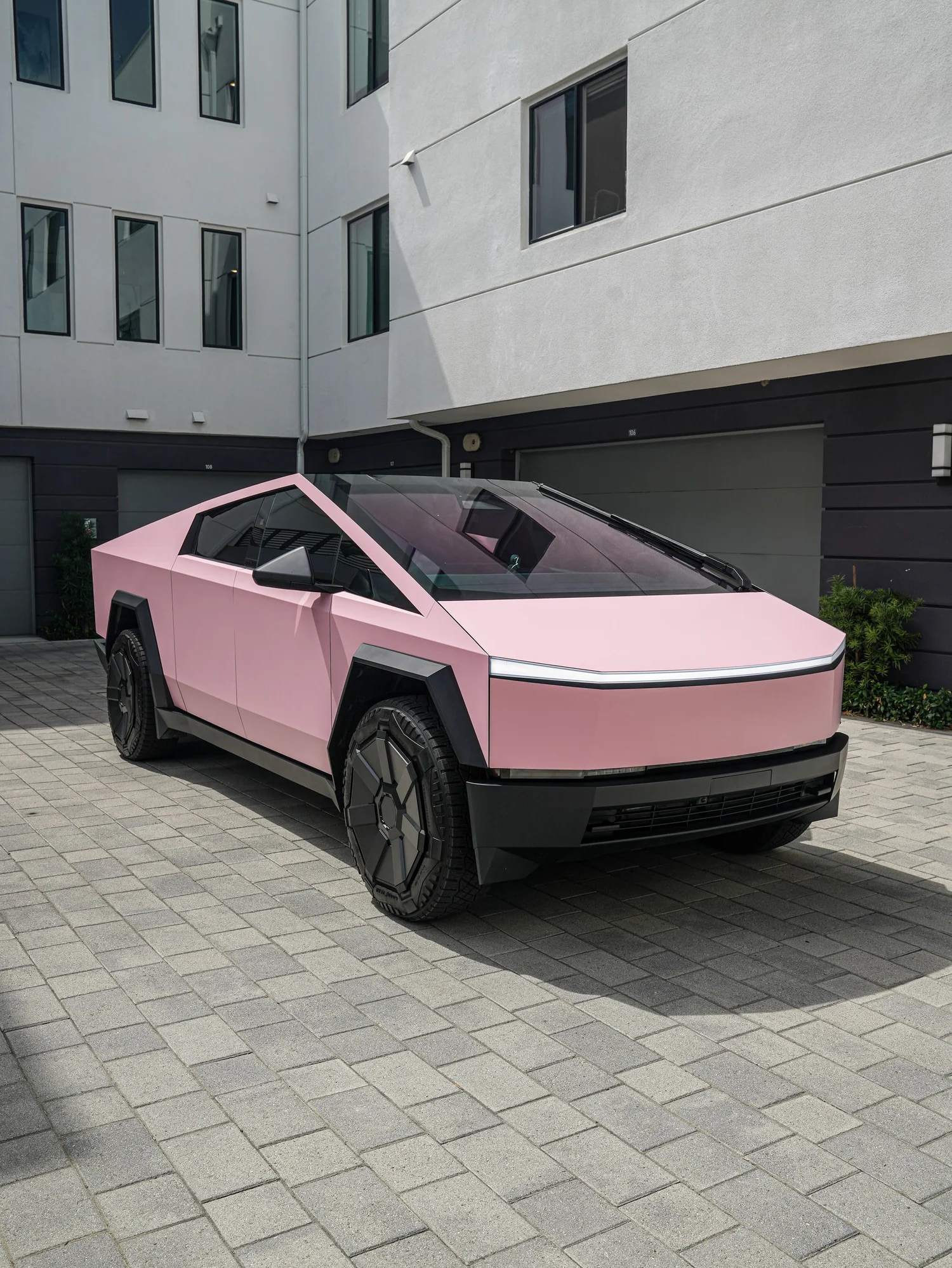 Satin Fresh Pink Tesla Cybertruck after Vinyl Wrap, front-left three-quarter view