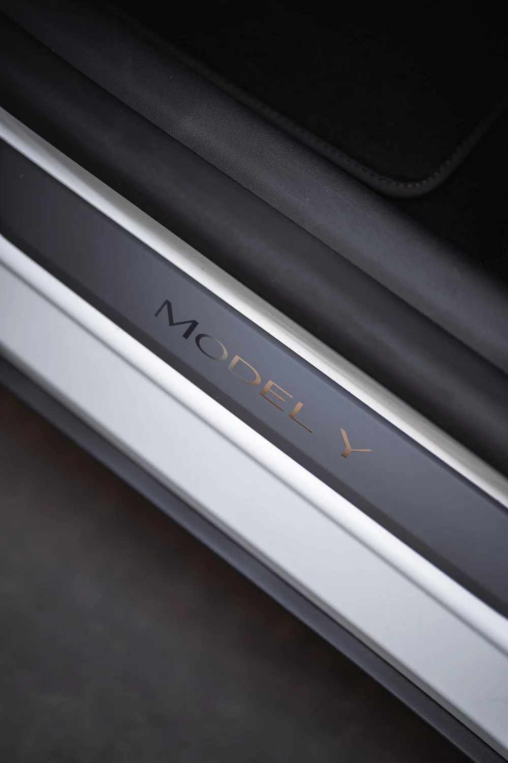 Interior door-sill photograph showing the Model Y lettering beside the cabin floor