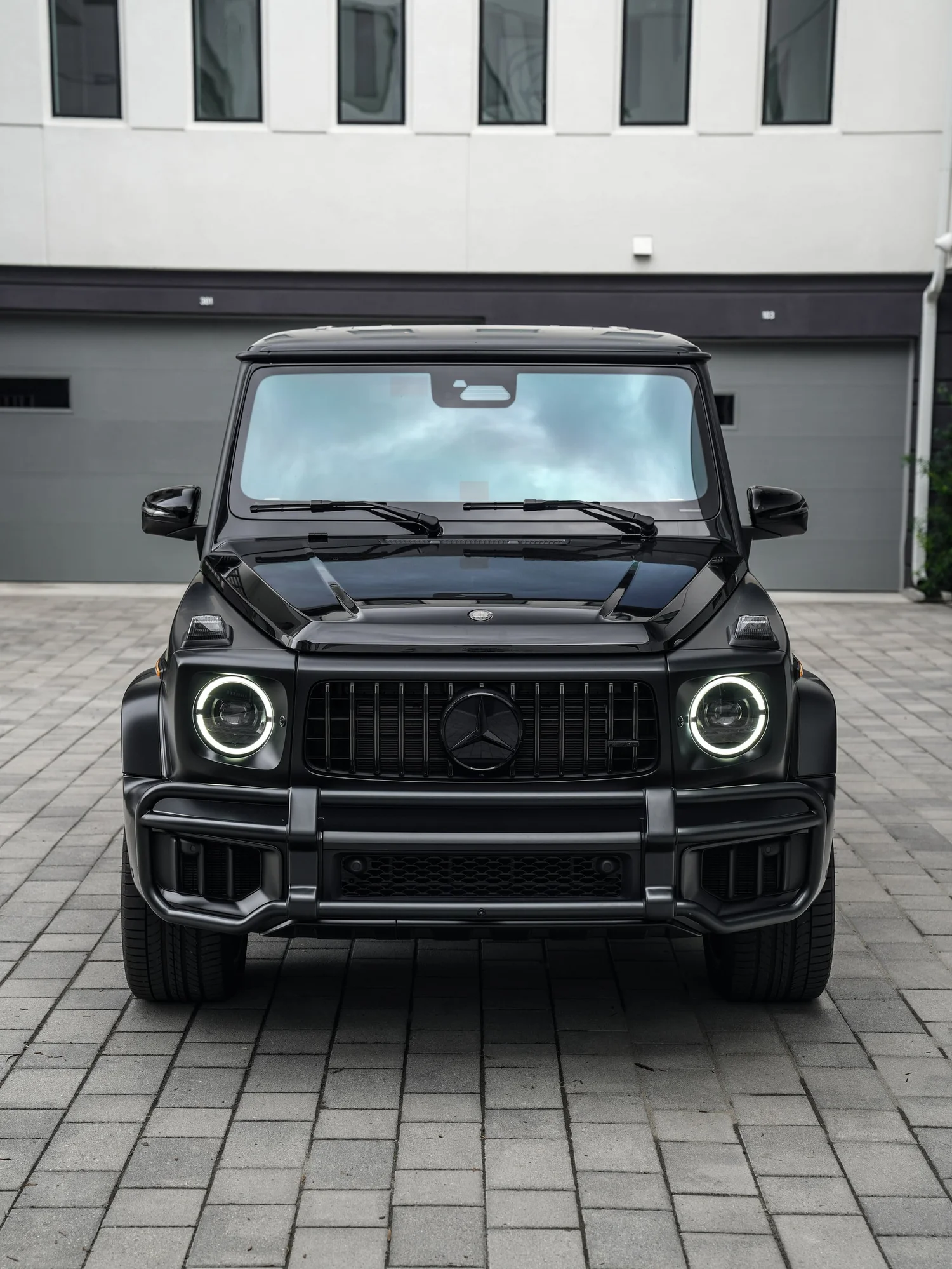 Mercedes-AMG G 63 Two-Tone Black after Paint Protection Film (PPF) and Window Tint, low-angle front view