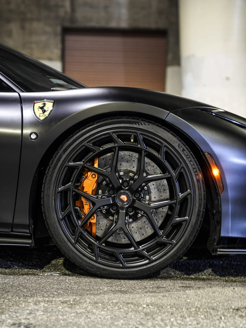 Front wheel, brake caliper and fender emblem close view — Ferrari F8 3M Satin Black vinyl wrap project