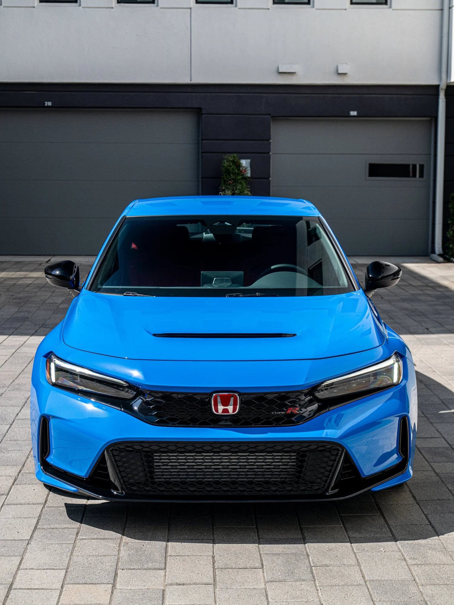 Straight front view of a Boost Blue Pearl 2026 Honda Civic Type R