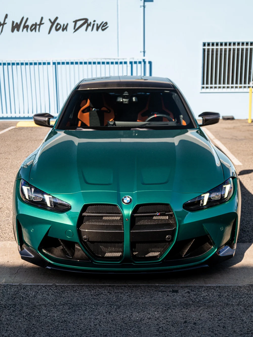Front view of the Isle of Man Green M3 with carbon front aero, dark roof and orange front seats