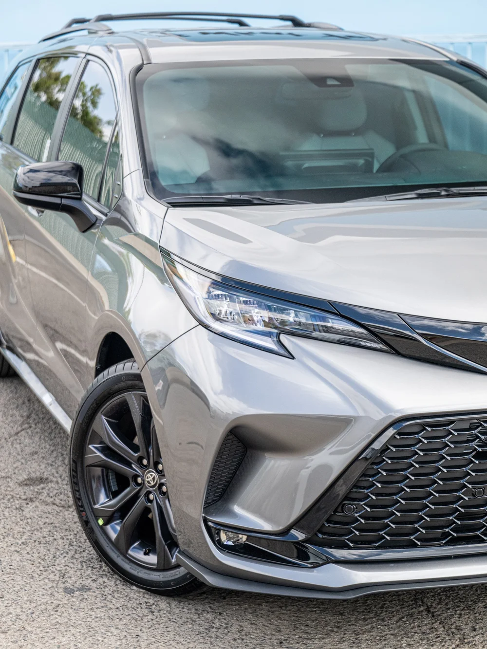 Front corner and wheel-face detail of a Heavy Metal 2026 Toyota Sienna XSE after ceramic protection