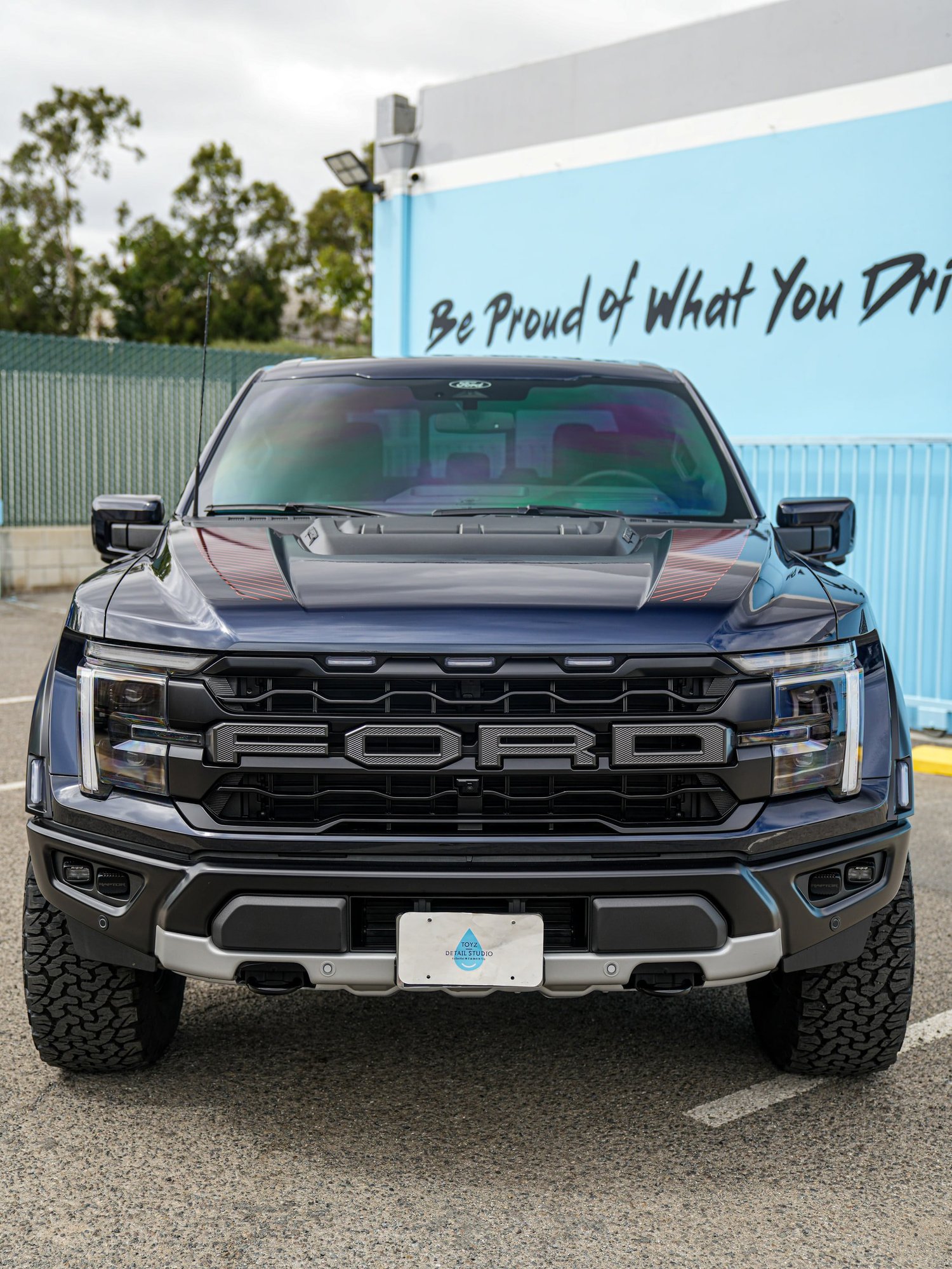 Dark Blue Ford F-150 Raptor after Paint Protection Film (PPF) and Window Tint, front-right three-quarter view