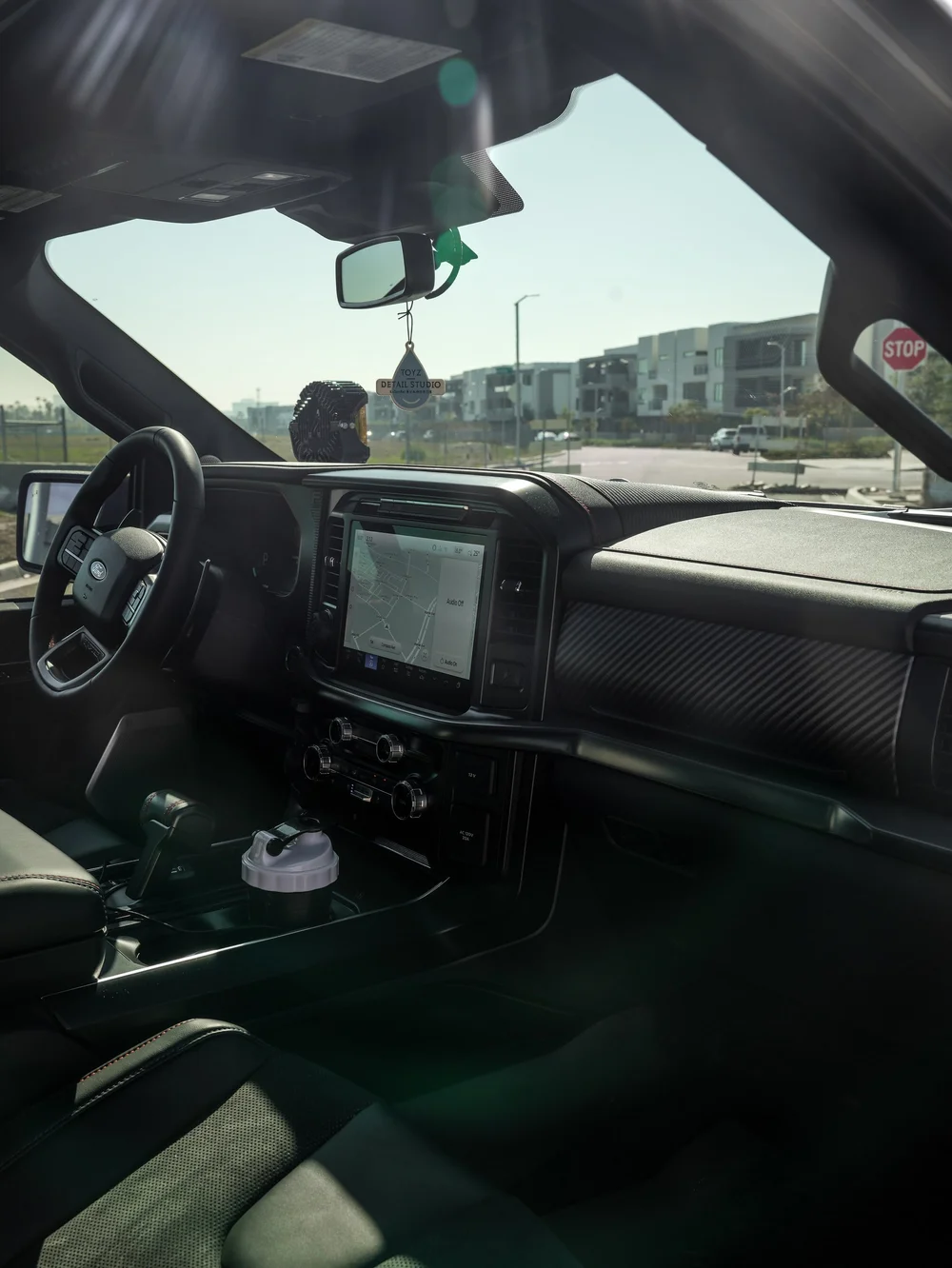 Black Ford F-150 Raptor, interior dashboard, windshield and front-seat view