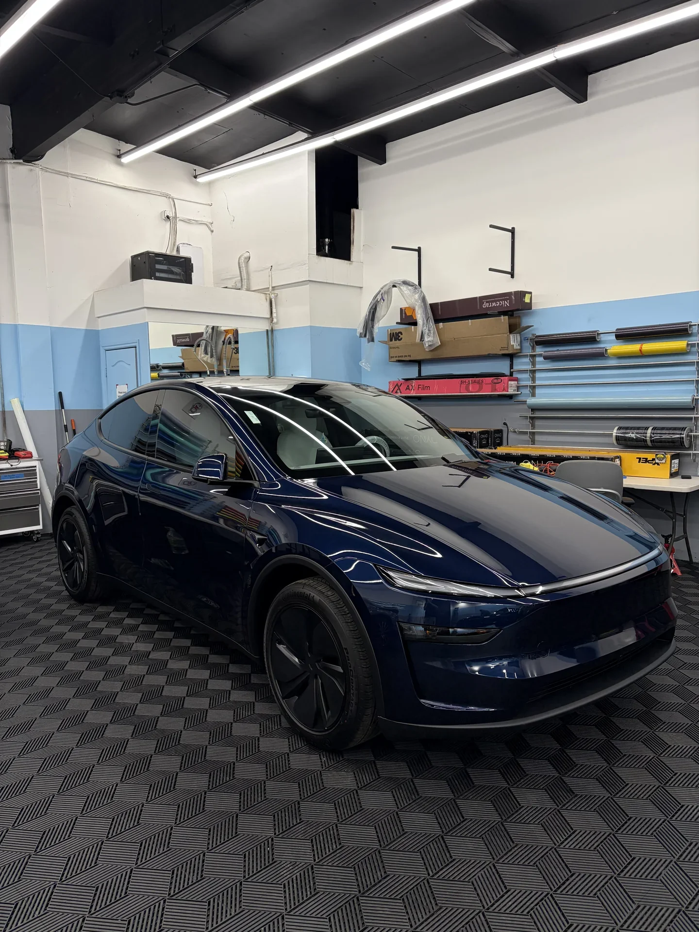 2026 Tesla Model Y — front three-quarter view inside the studio