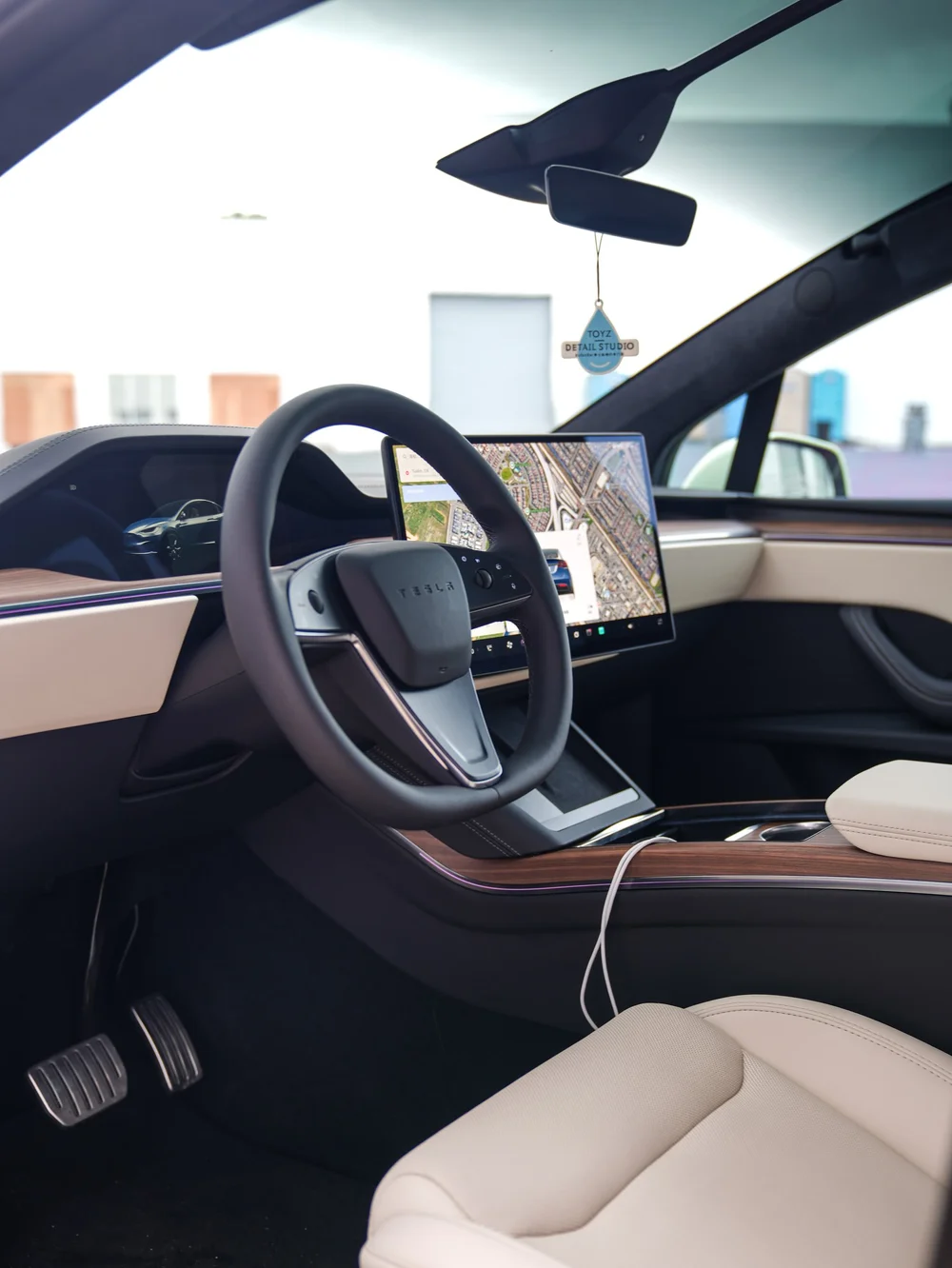 Steering wheel, dashboard and light-colored front seat through the open door — Tesla Model X Avocado Green vinyl wrap project