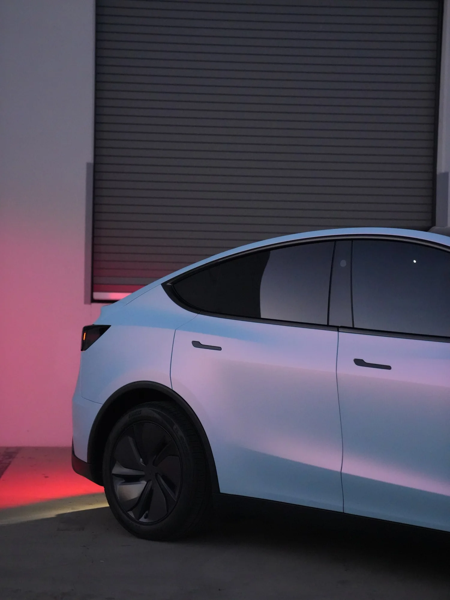 Tesla Model Y Color-Shifting White-to-Blue after Vinyl Wrap, rear-quarter and wheel view