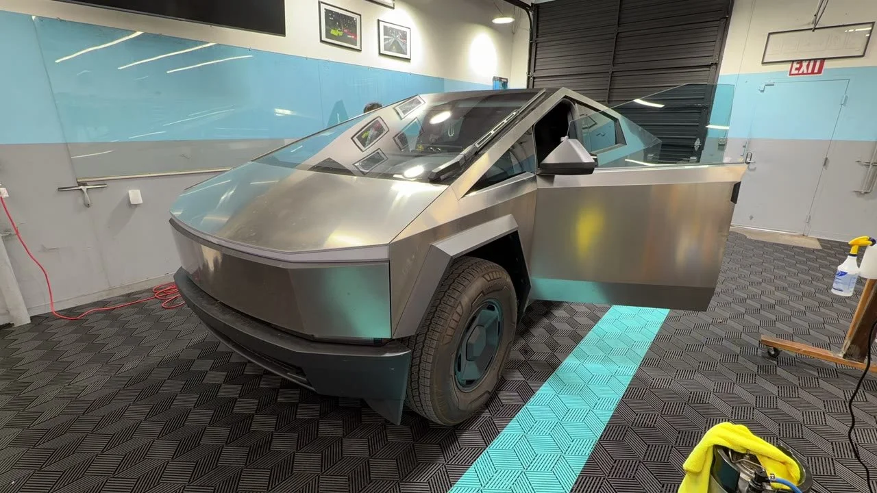2026 Tesla Cybertruck — video frame showing the front and side with a door open inside the studio
