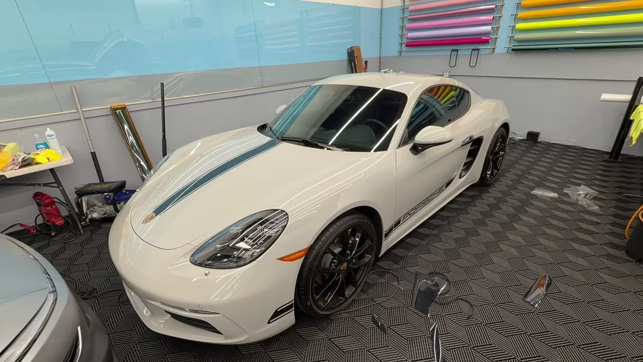 2024 Porsche 718 Cayman Base — video frame showing the front and side of the coupe inside the studio