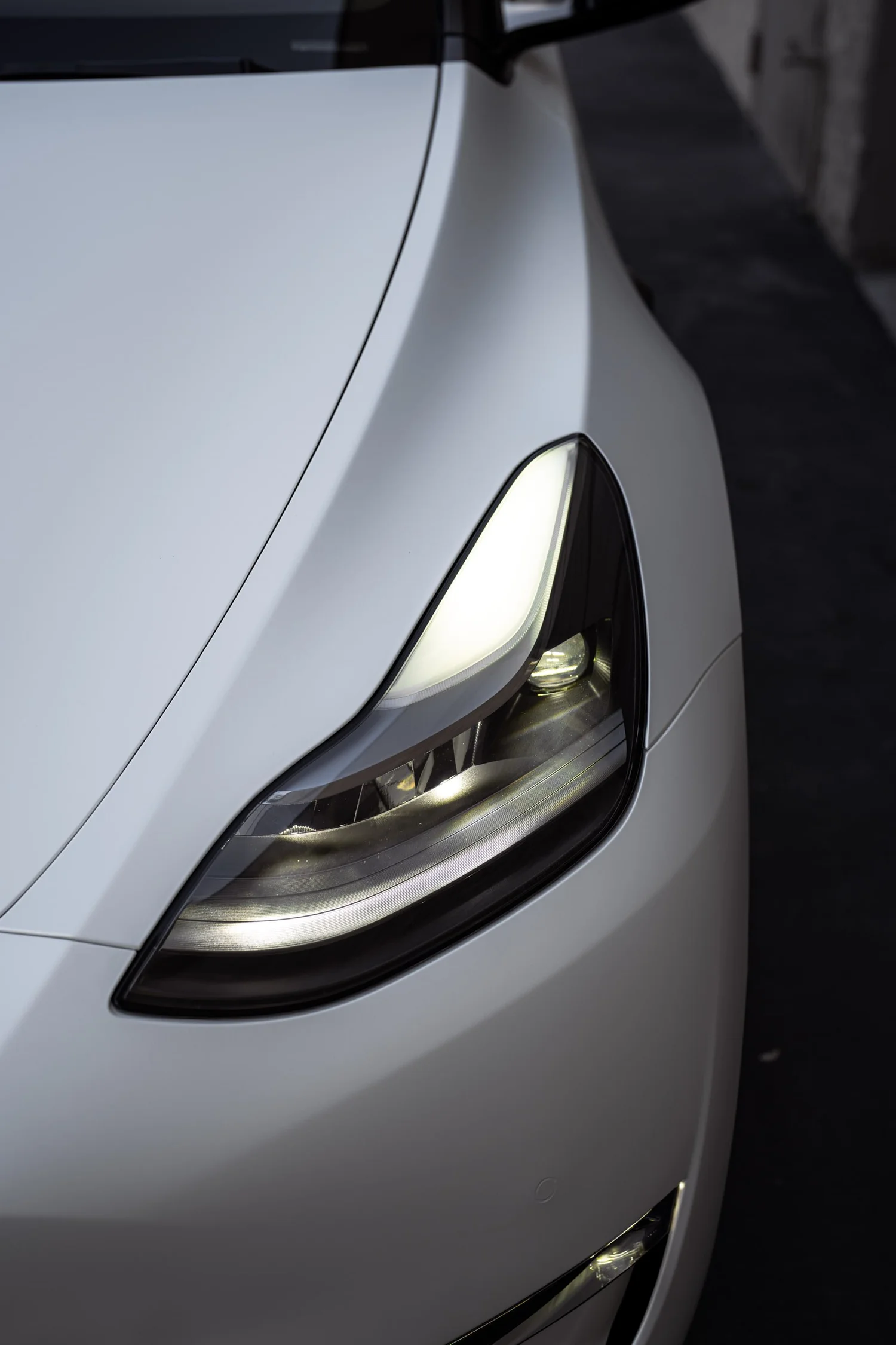 Satin Pearl White Tesla Model Y after Vinyl Wrap, front-corner view