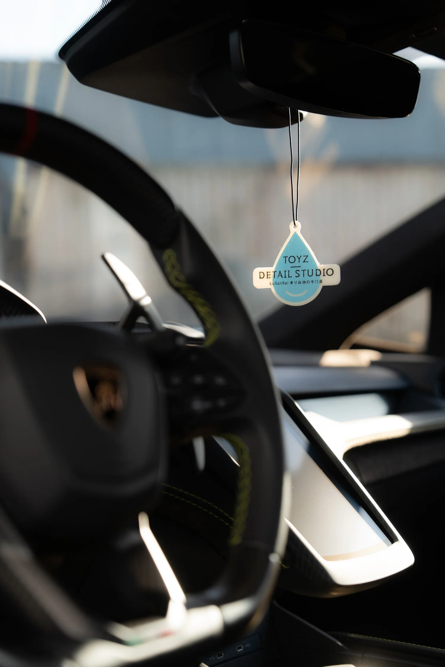 Revuelto steering wheel and rear-view mirror with a Toyz Detail Studio hanger.