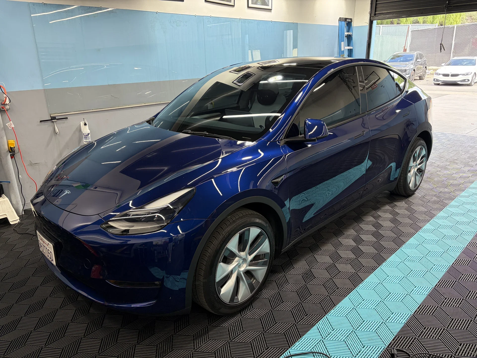 2026 Tesla Model Y — front three-quarter view inside the studio