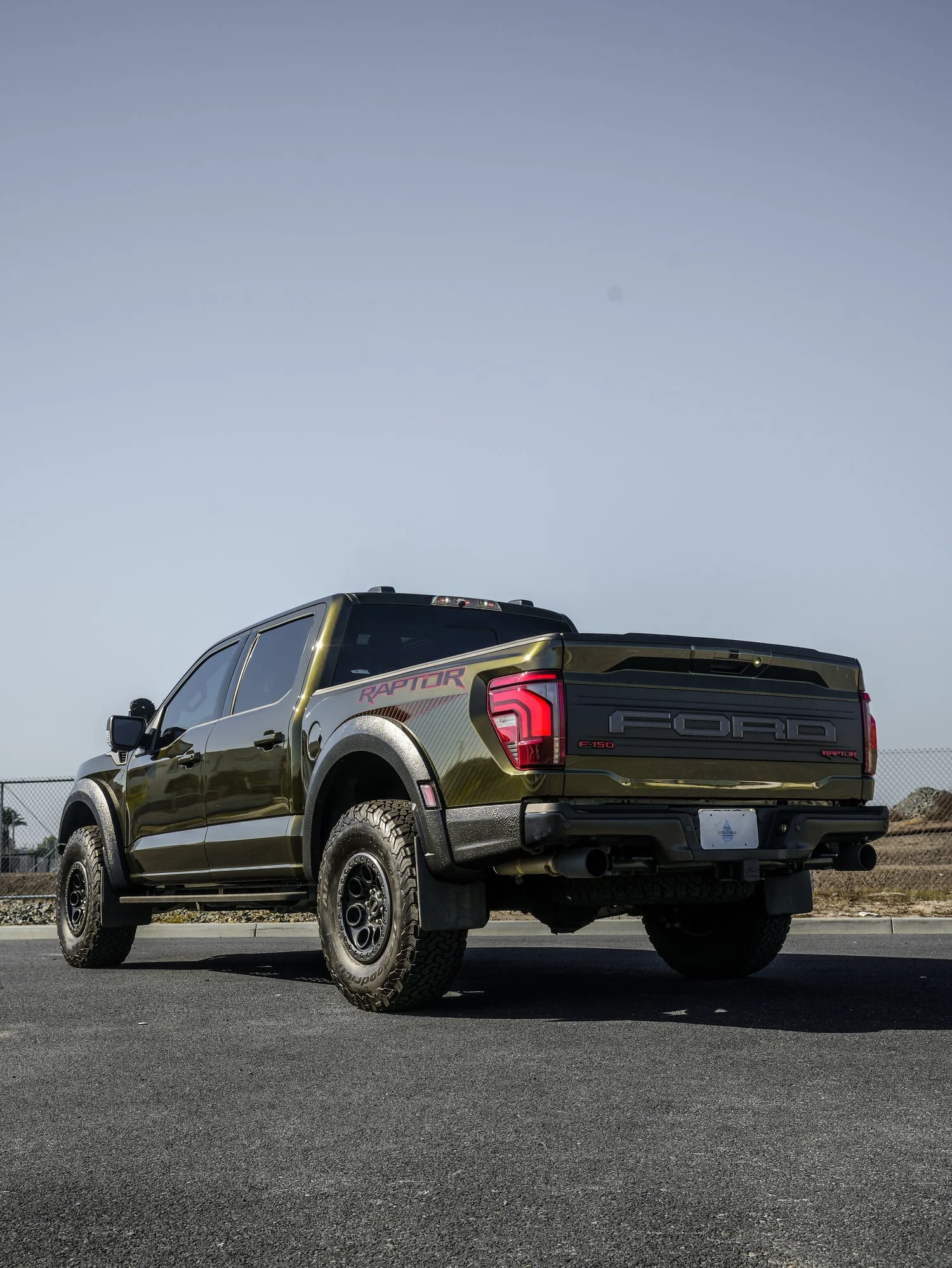 Black Ford F-150 Raptor after Paint Protection Film (PPF) and Window Tint, rear-left three-quarter view