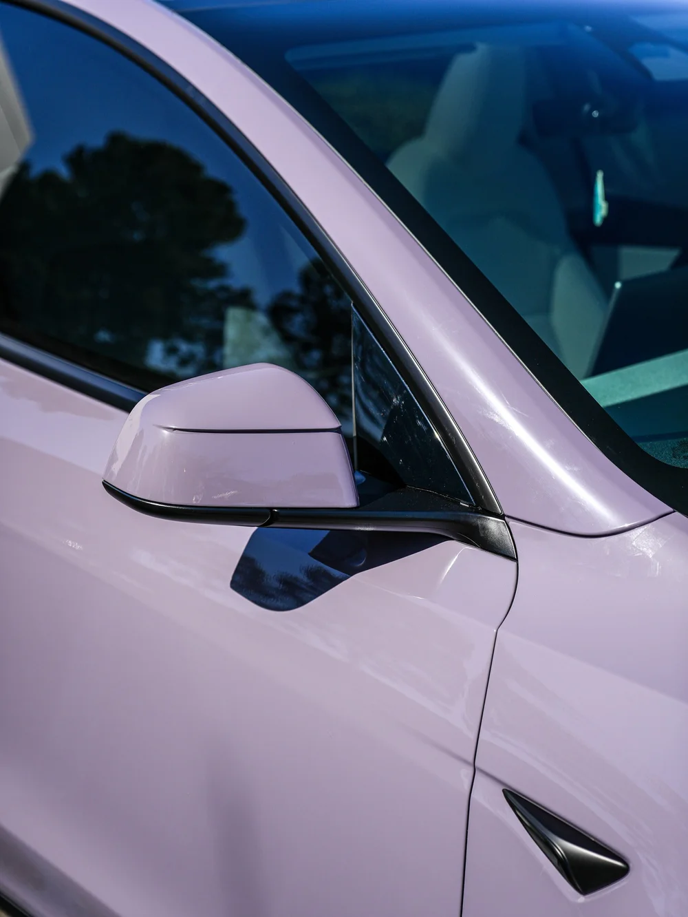 Tesla Model Y with Provence Violet vinyl wrap, side mirror, front door and window-trim close-up