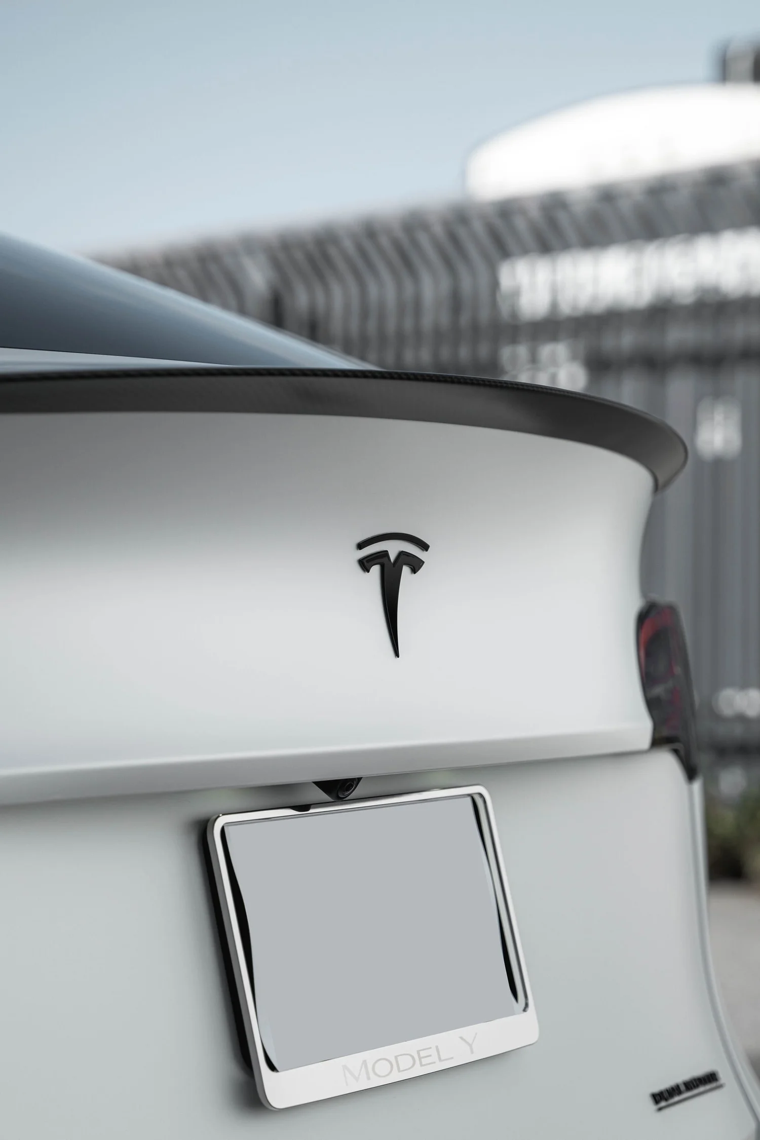 Satin Pearl White Tesla Model Y with Custom Exterior Accents after Vinyl Wrap, close rear view