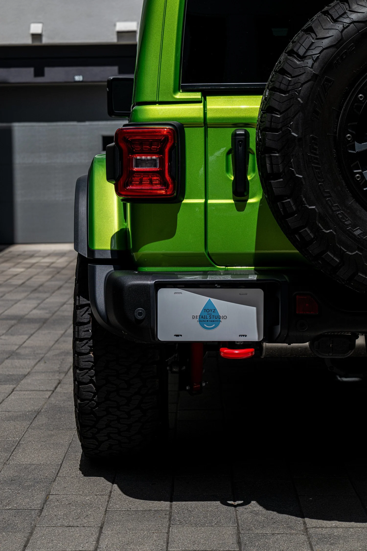 Rear taillight and Mojito tailgate hinge area beside the Rubicon spare tire