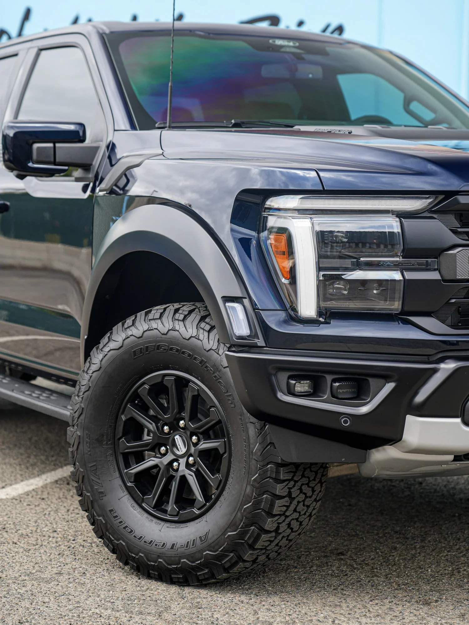 Dark Blue Ford F-150 Raptor after Paint Protection Film (PPF) and Window Tint, front wheel and body view
