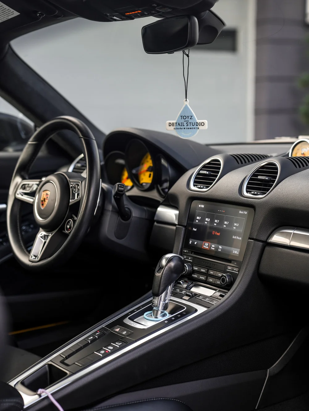 Porsche 718 Cayman GTS with 3M Satin Black vinyl wrap, interior dashboard and center console