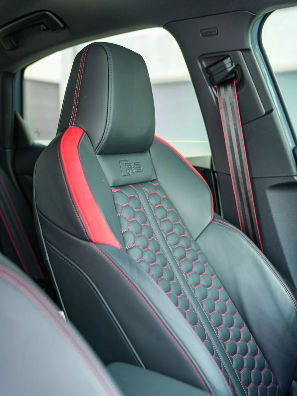 Audi RS front seat with red side accents and contrasting diamond-pattern stitching