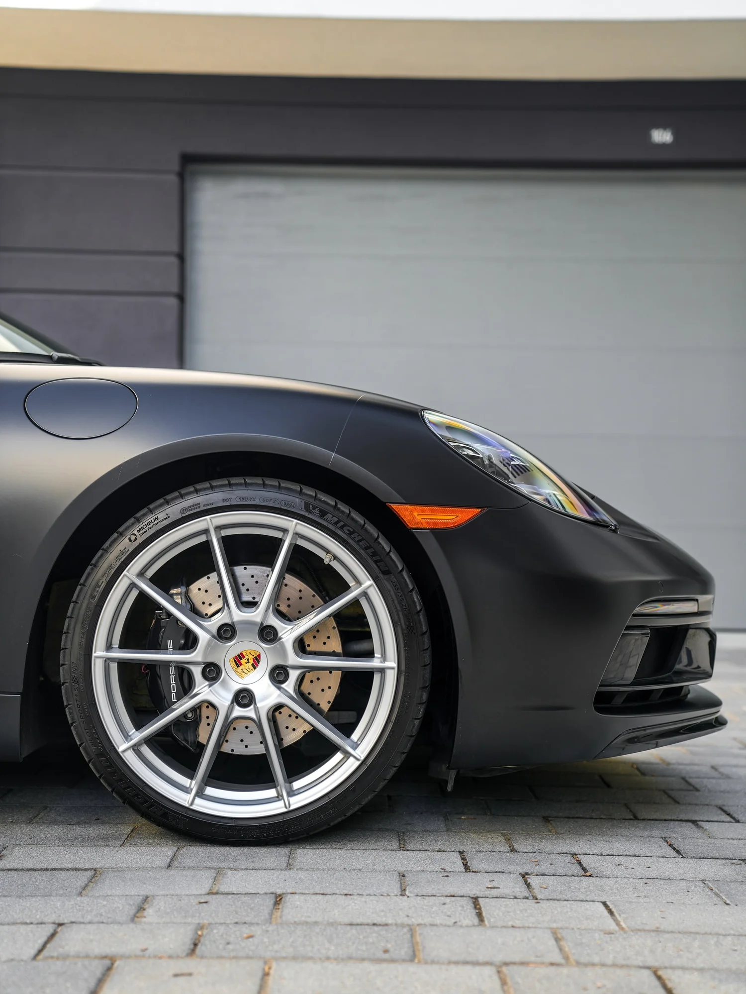 Porsche 718 Cayman GTS 3M Satin Black after Vinyl Wrap, front wheel and body view