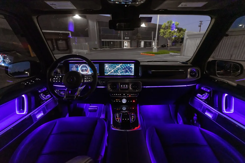 Mercedes-AMG G 63, wide cabin view with dashboard, steering wheel and purple lighting