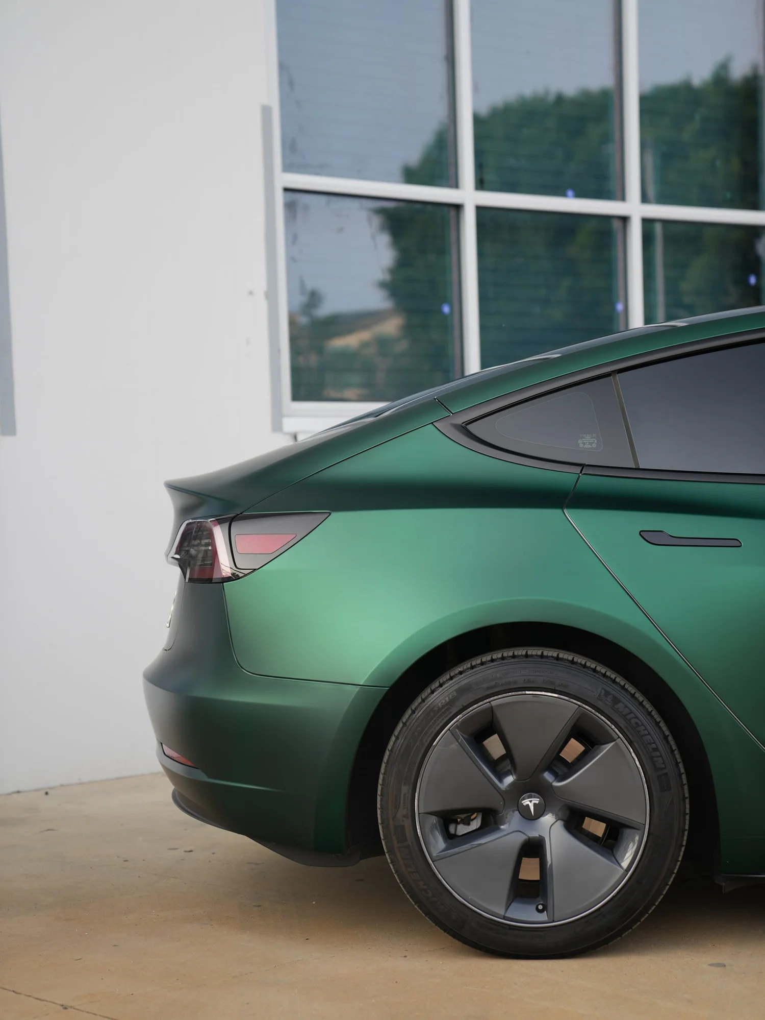 Tesla Model 3 Ghost Matte Green after Vinyl Wrap, rear-quarter and wheel view