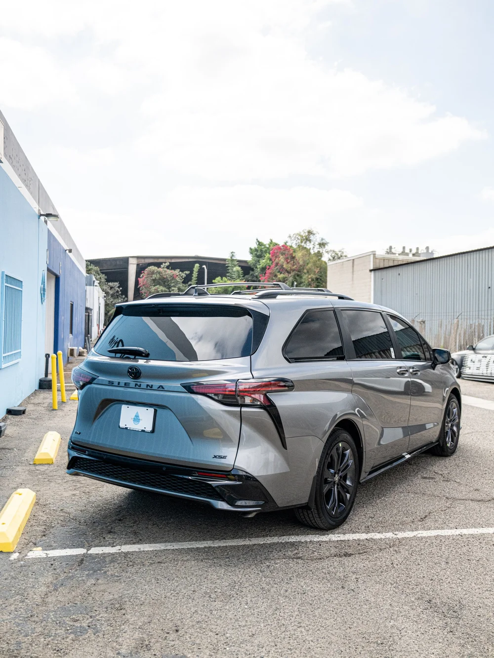 Rear three-quarter view of a Heavy Metal 2026 Toyota Sienna XSE after ceramic coating and tint
