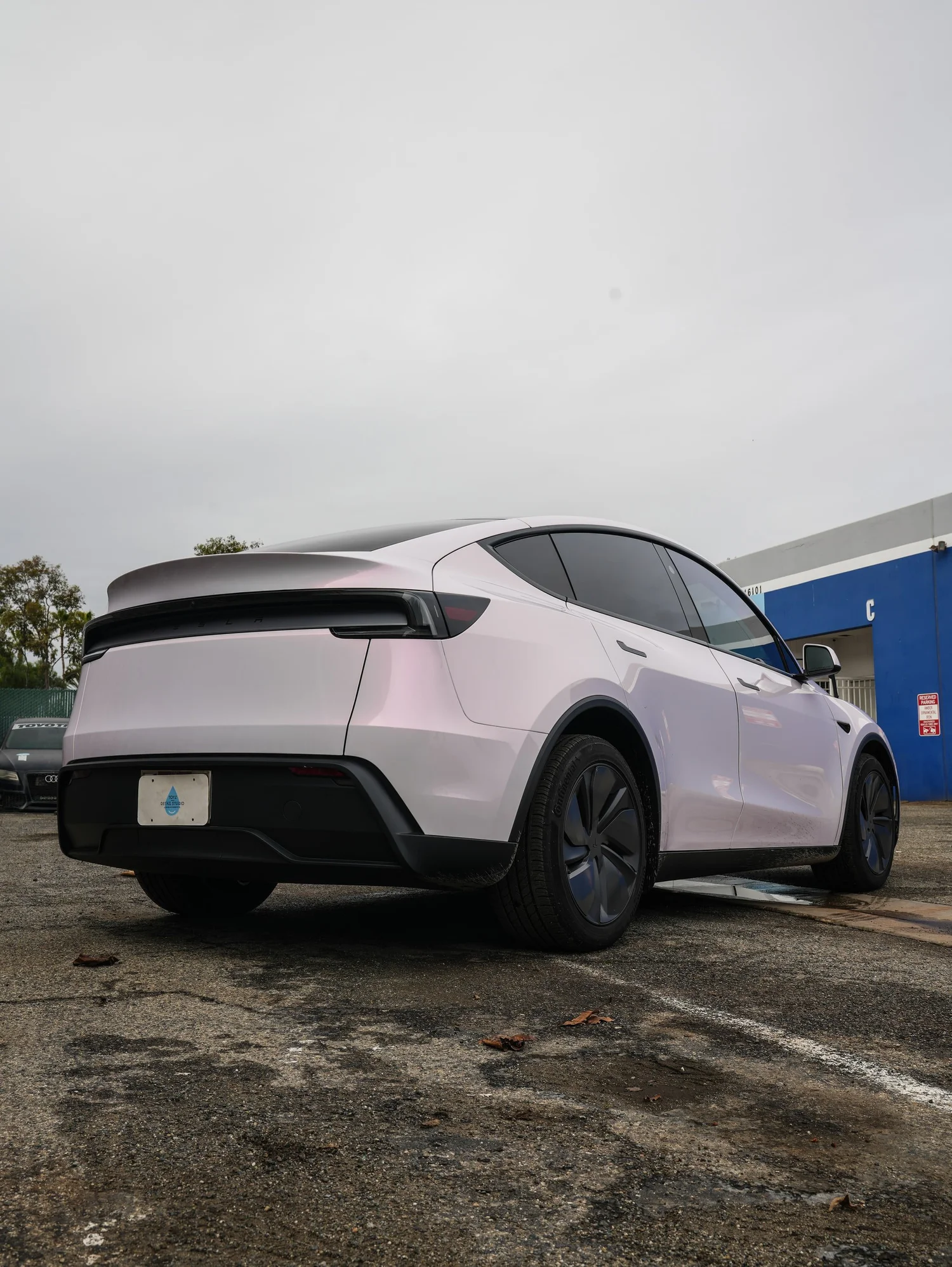 Pale Blush Pink Tesla Model Y after Vinyl Wrap, rear-right three-quarter view