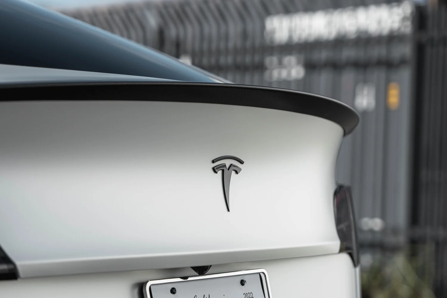 Satin Pearl White Tesla Model Y with Custom Exterior Accents after Vinyl Wrap, charging-port detail