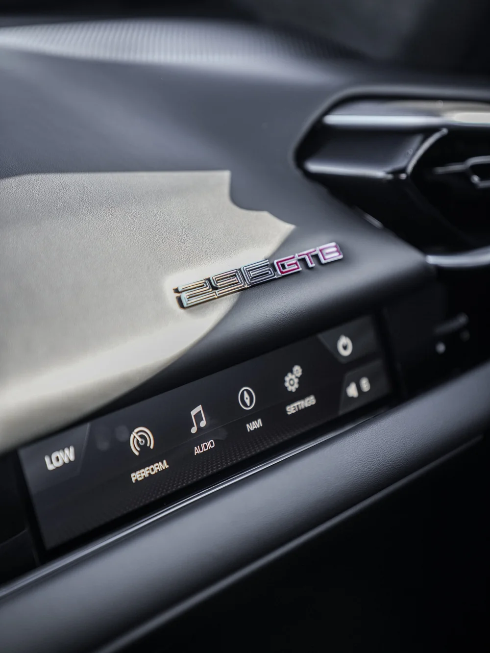 Ferrari dashboard badge reading 296GTB above the passenger display
