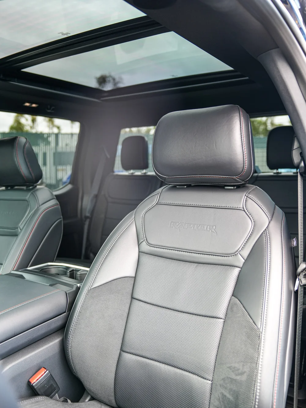 Dark Blue Ford F-150 Raptor, front passenger seat and roof-glass view