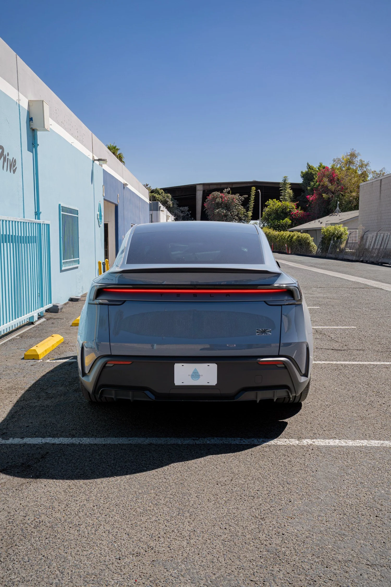 Glacier Blue Model Y Performance rear view in the Toyz Detail Studio parking area