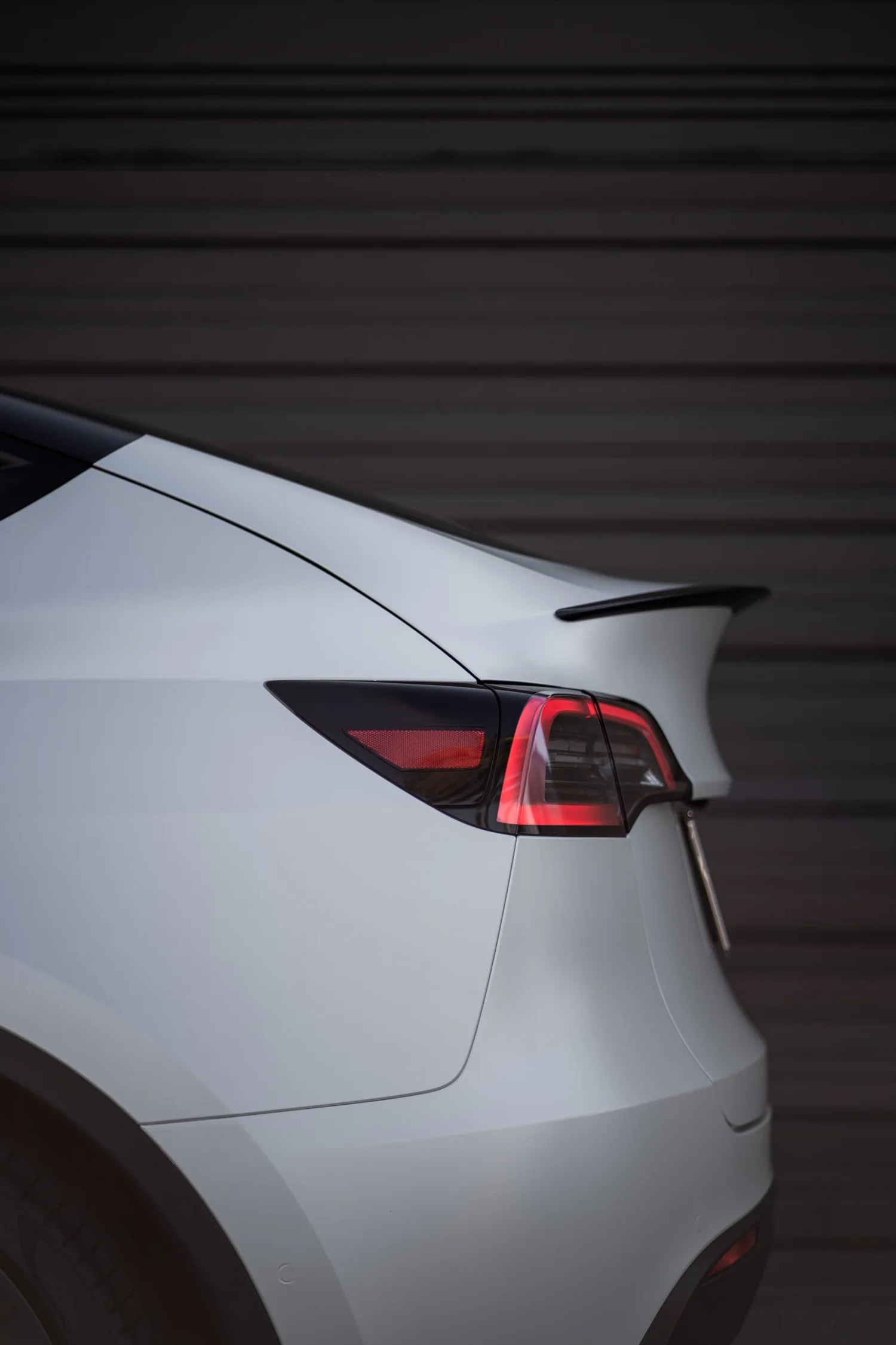 Satin Pearl White Tesla Model Y after Vinyl Wrap, rear body and taillight view