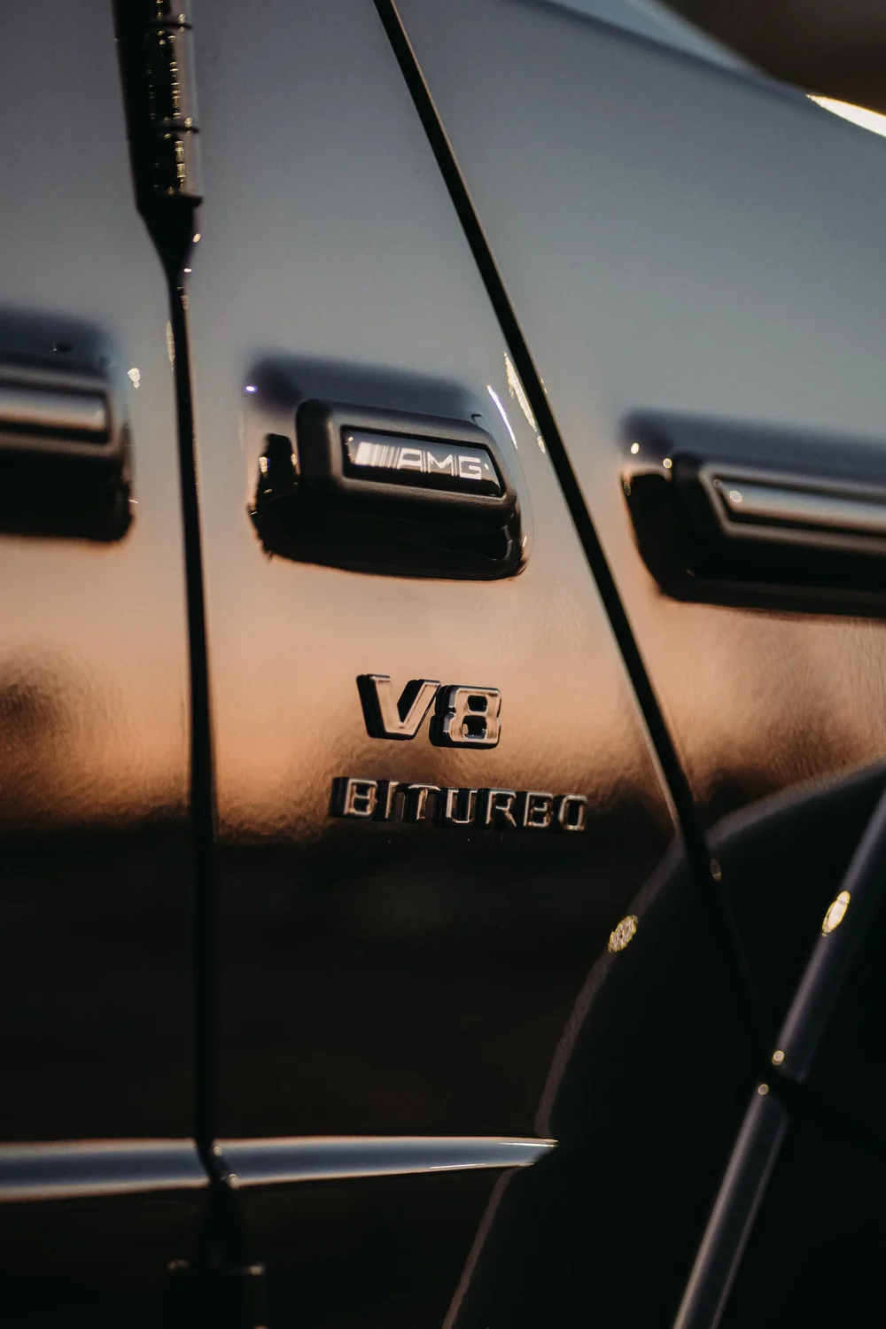 Mercedes-AMG G 63, V8 BITURBO badge and side-trim close-up