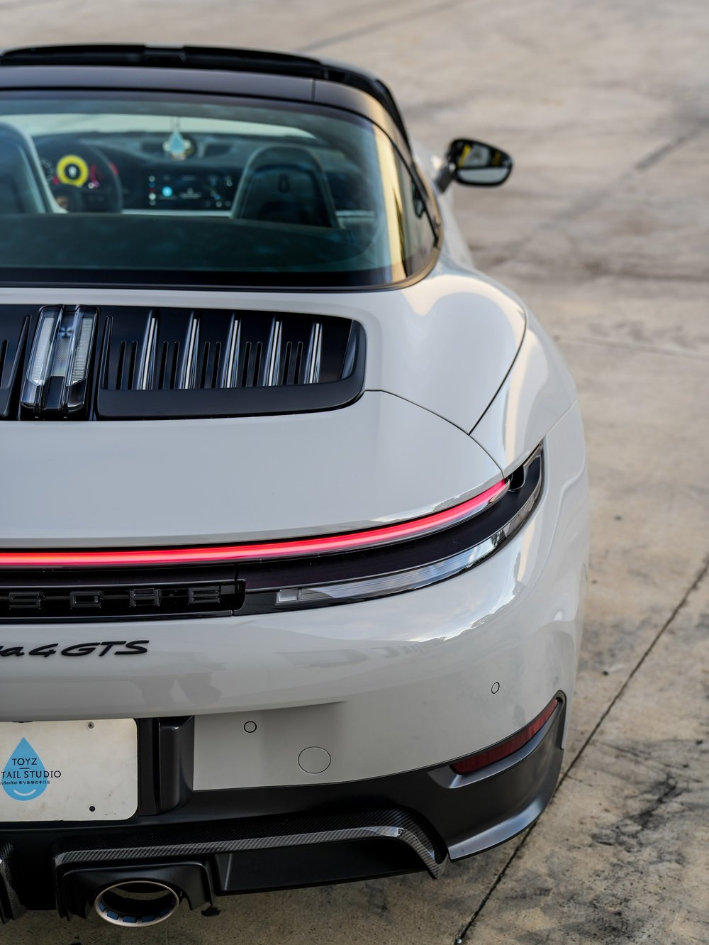 Porsche Targa rear corner with curved glass, vented cover and illuminated light bar