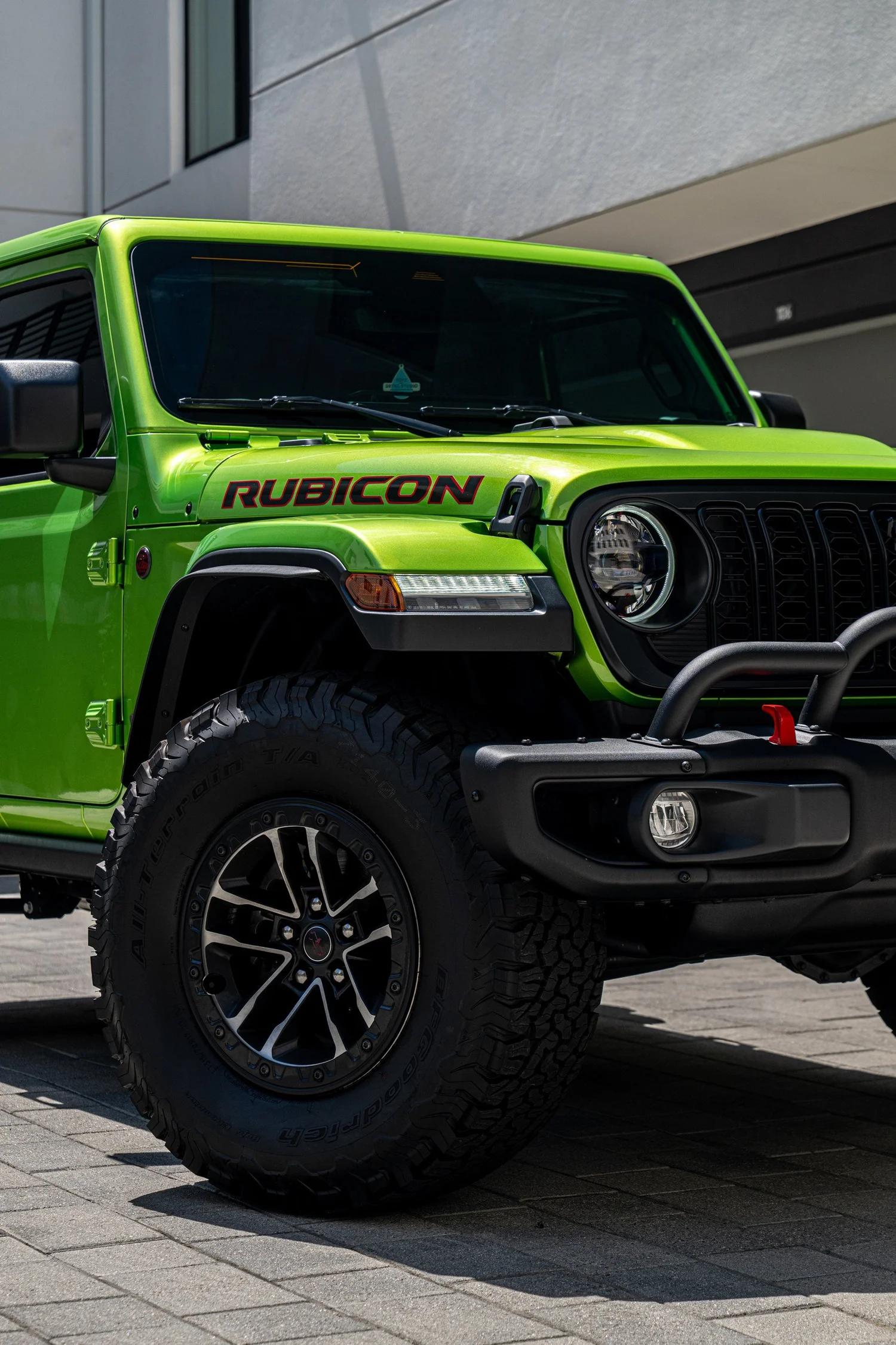 Front quarter of the Mojito Rubicon showing its hood graphic, round headlight, front wheel and black bumper