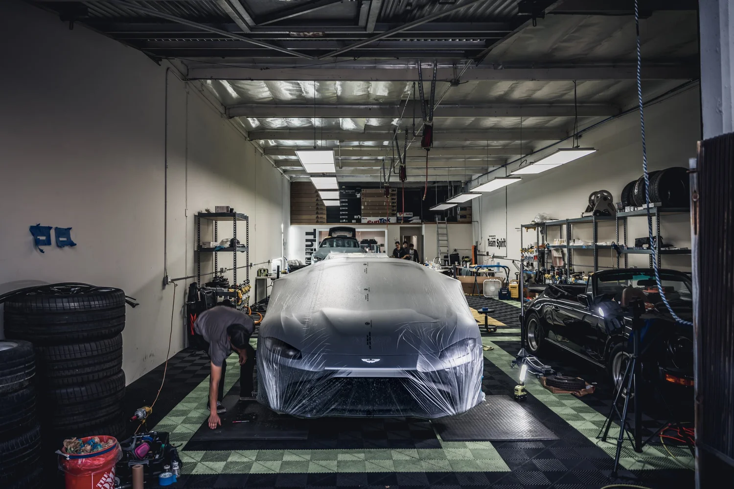 Aston Martin Vantage Acid Green after Brake Caliper Repaint, wide indoor studio view