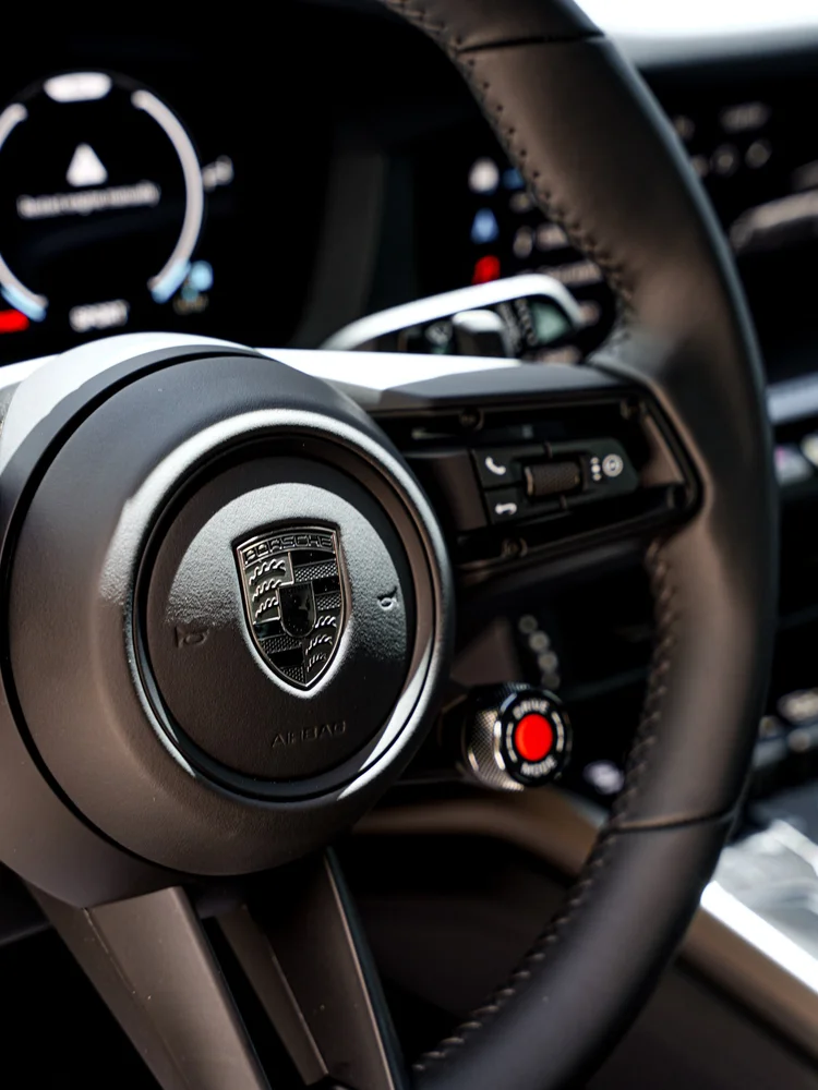 Porsche crest, controls and stitching on the Turbo S steering wheel.