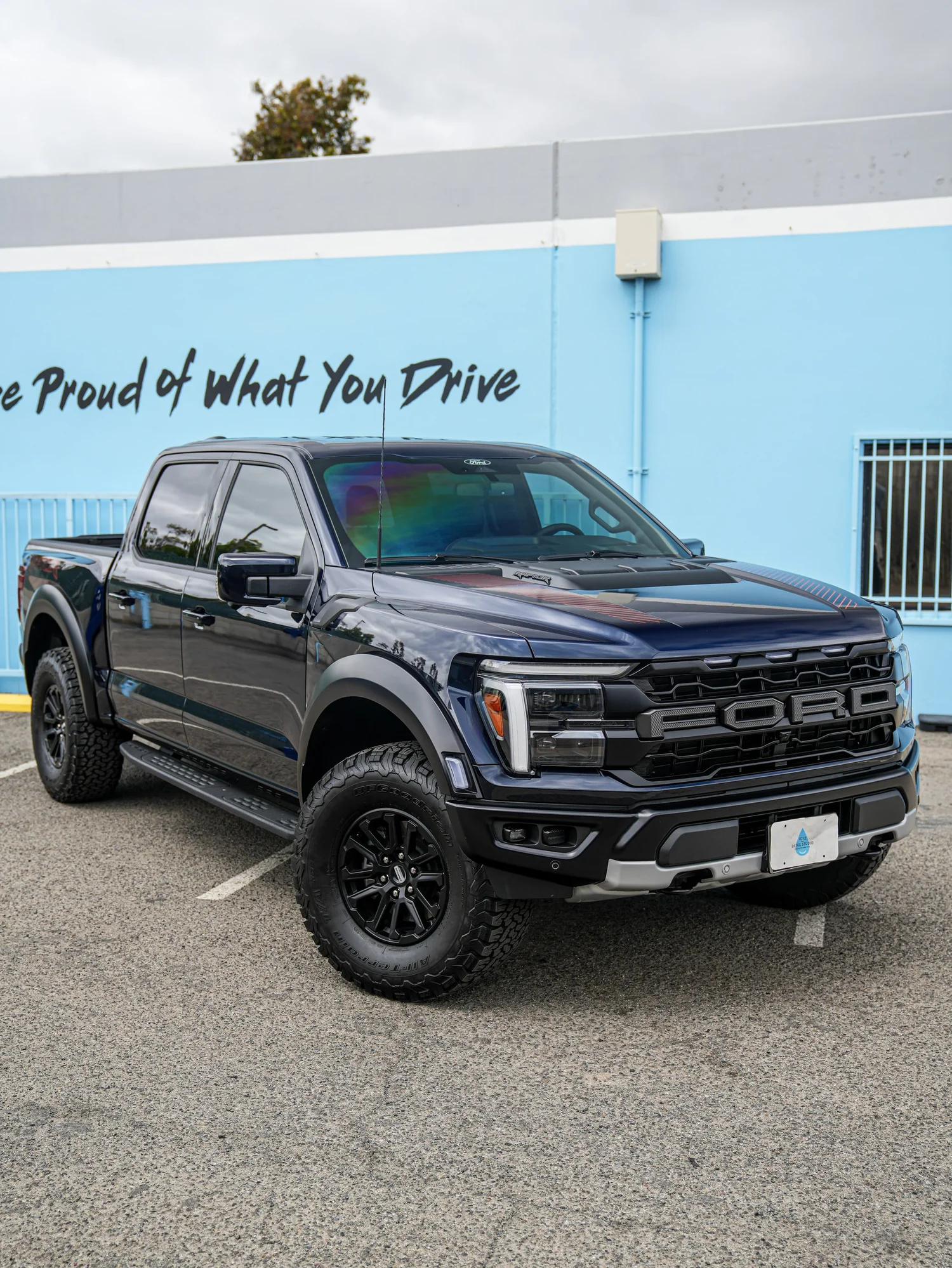 Dark Blue Ford F-150 Raptor after Paint Protection Film (PPF) and Window Tint, front-left three-quarter view