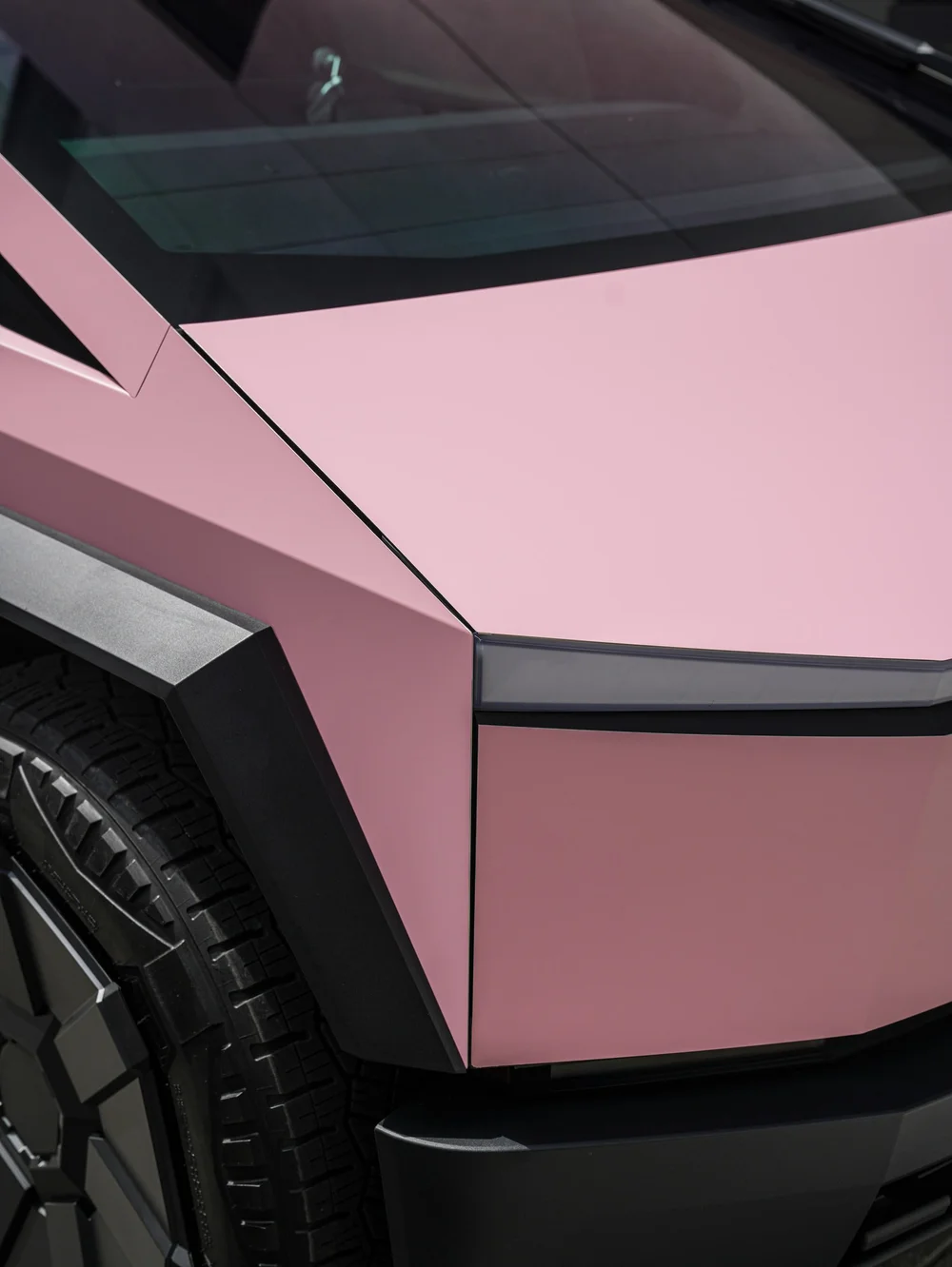 Tesla Cybertruck with Satin Fresh Pink vinyl wrap, hood, front fender and body-panel finish detail