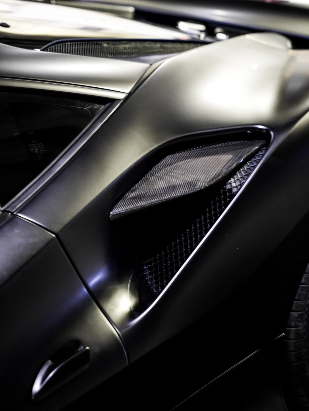 Sculpted rear-quarter surface and side-intake close view — Ferrari F8 3M Satin Black vinyl wrap project