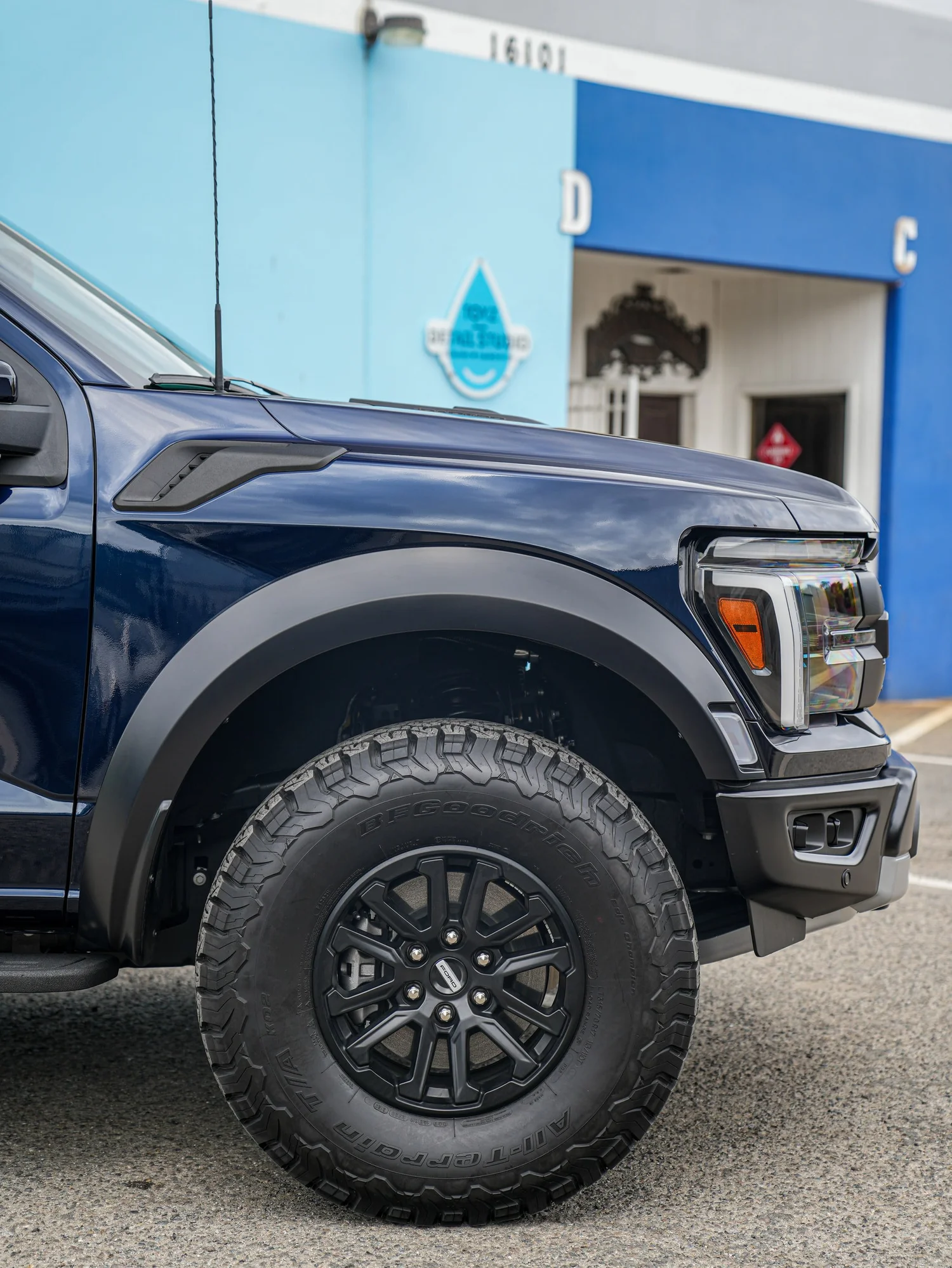Dark Blue Ford F-150 Raptor after Paint Protection Film (PPF) and Window Tint, front-fender and wheel view