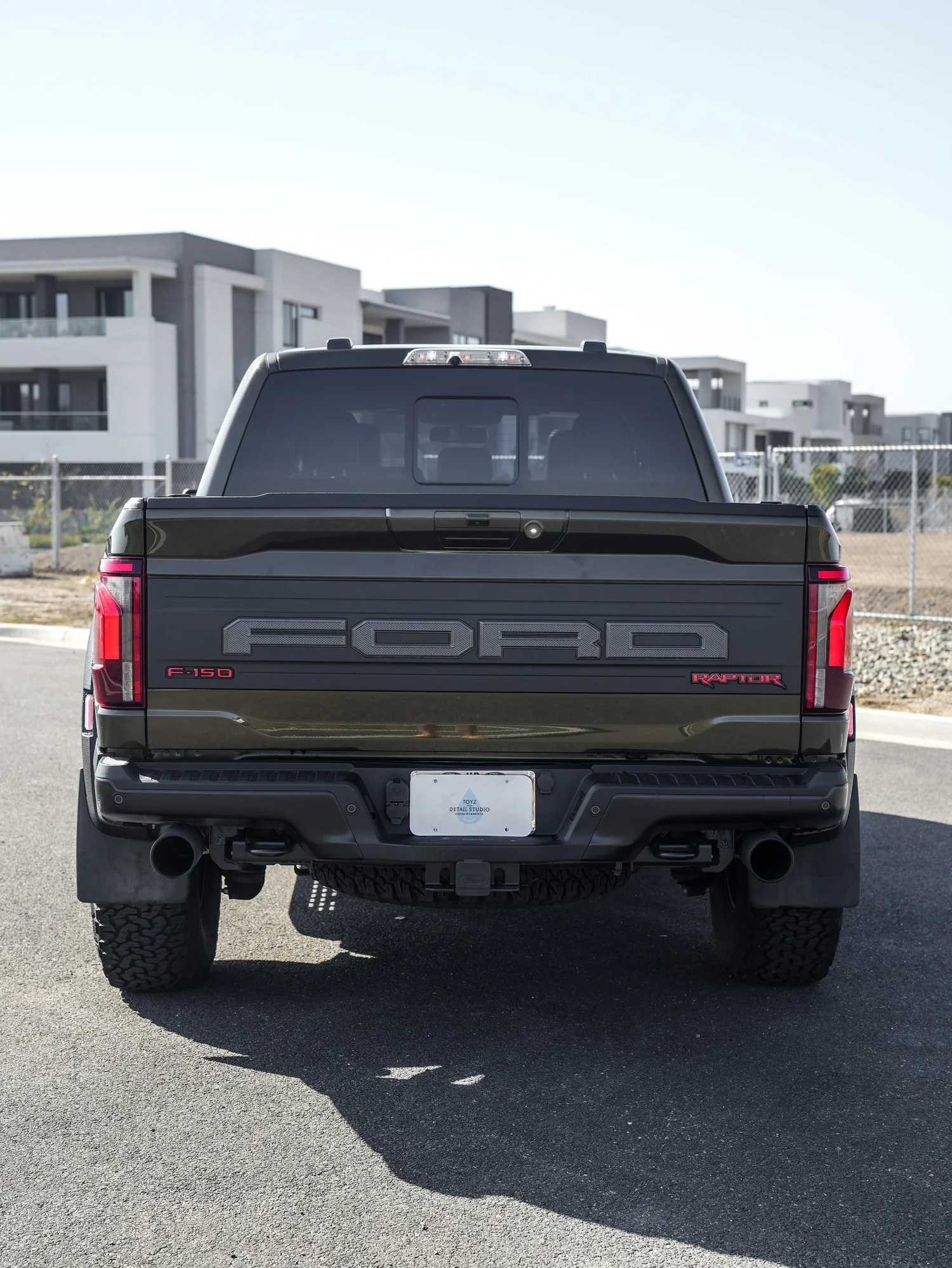 Black Ford F-150 Raptor after Paint Protection Film (PPF) and Window Tint, rear-right three-quarter view