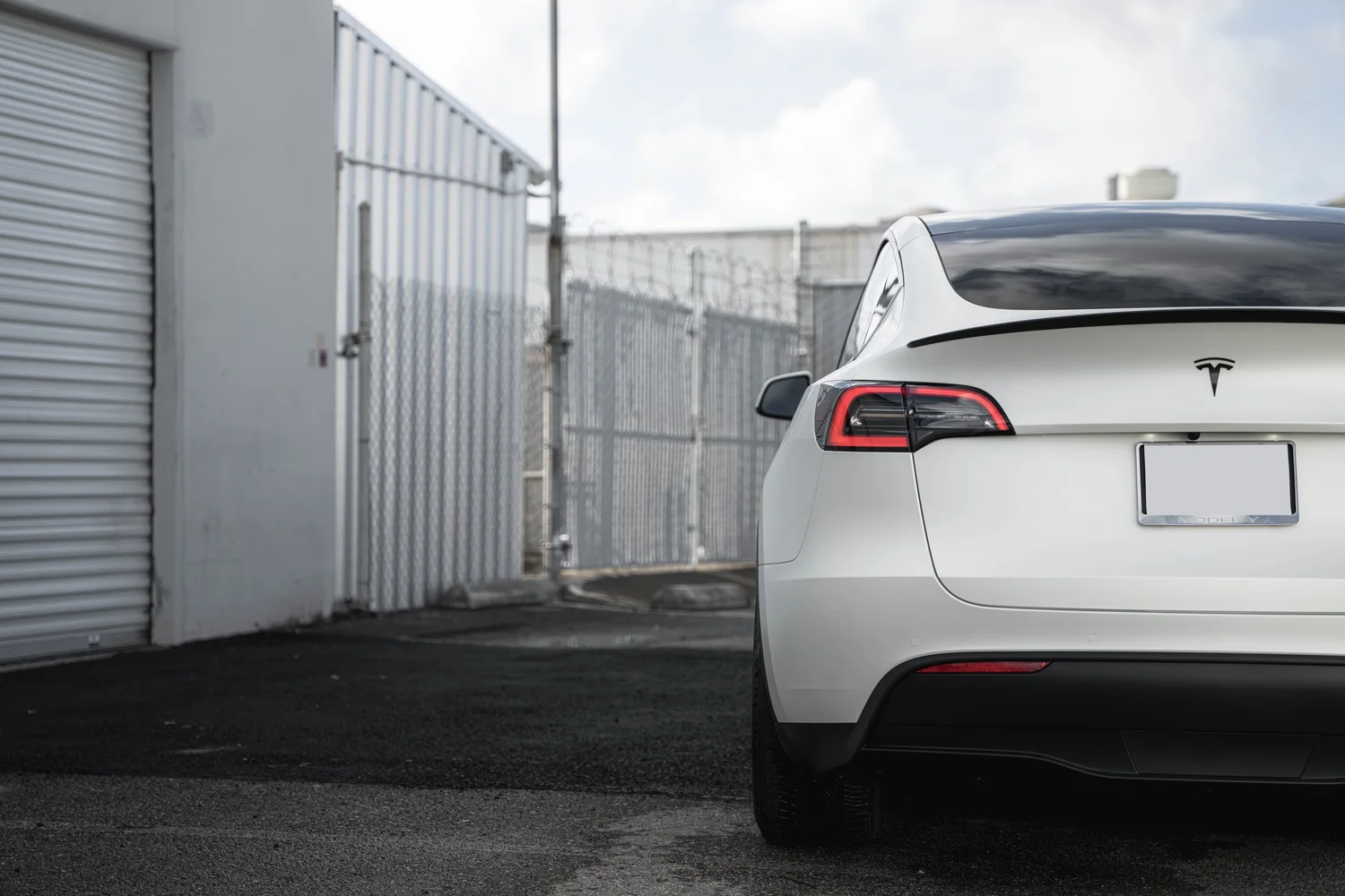 Satin Pearl White Tesla Model Y with Custom Exterior Accents after Vinyl Wrap, direct rear view